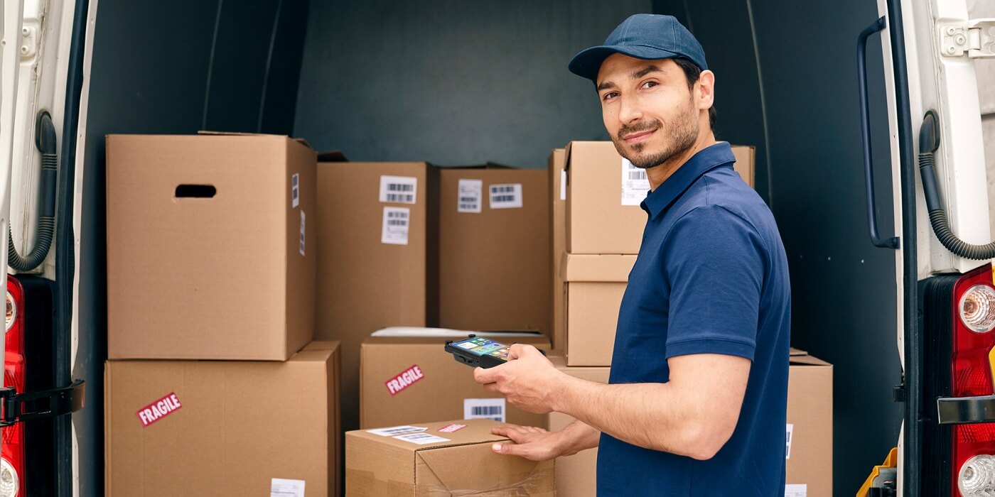 Using a mobile barcode scanner to scan goods on a delivery truck Using a mobile barcode scanner to scan goods on a delivery truck